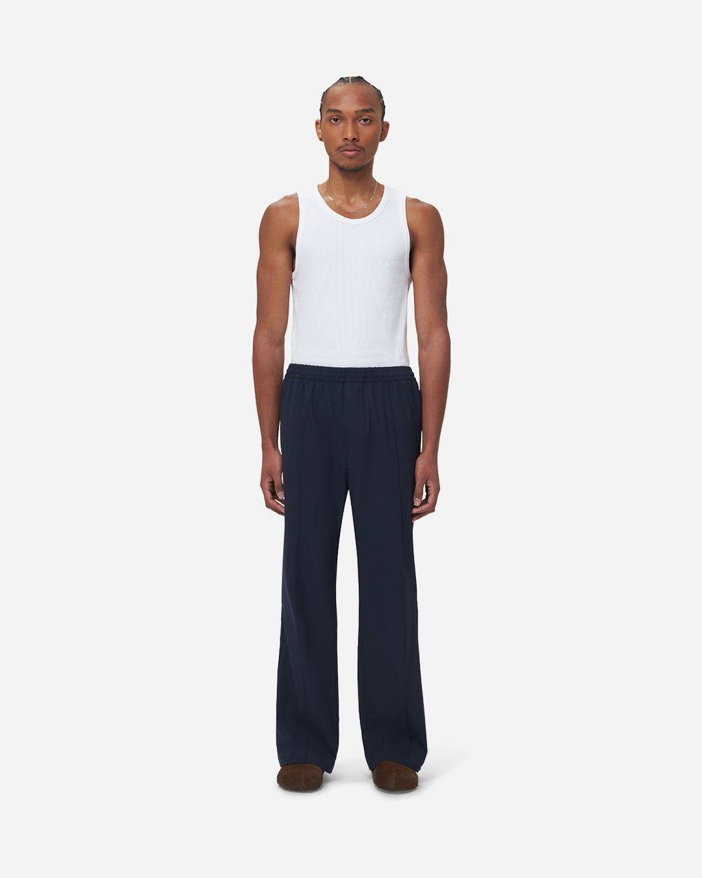 The Chesed, Wide Leg Trousers are cut to a unisex wide fit with a mid waist and long length. Crafted from a cotton blend with pressed creases.