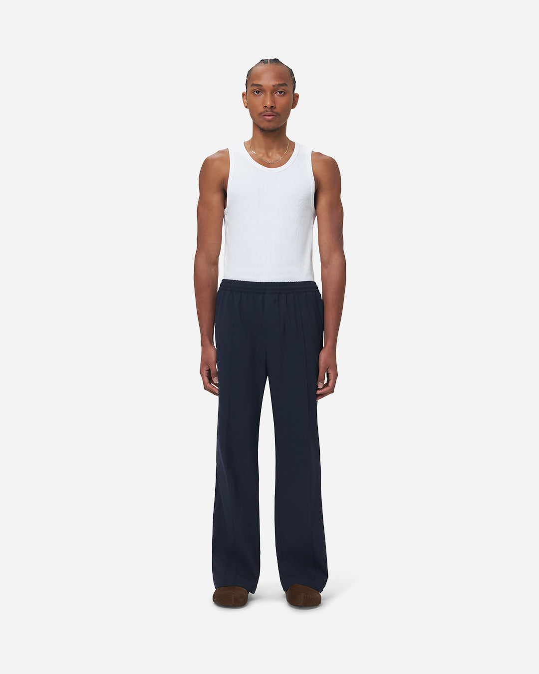 The Chesed, Wide Leg Trousers are cut to a unisex wide fit with a mid waist and long length. Crafted from a cotton blend with pressed creases.