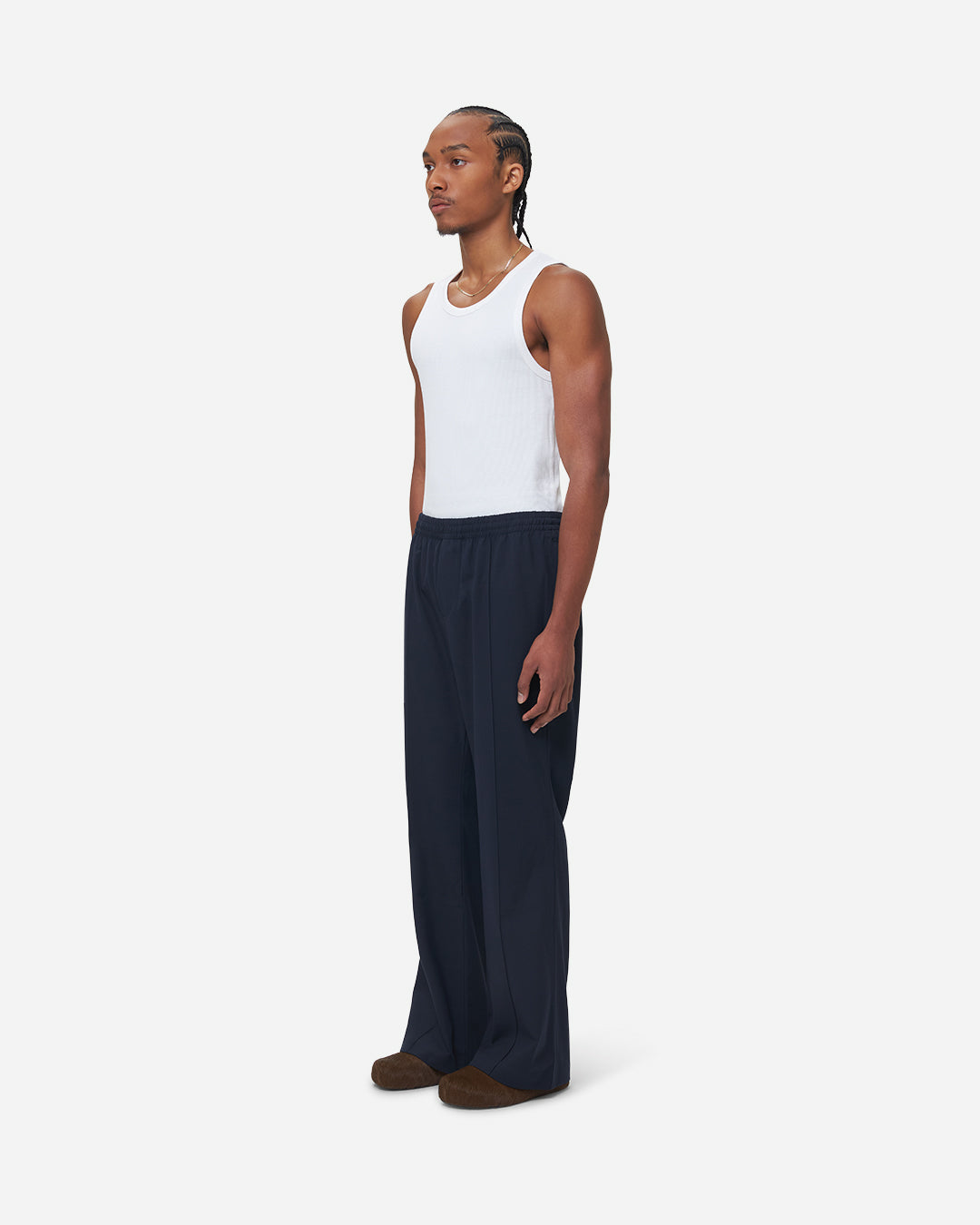 The Chesed, Wide Leg Trousers are cut to a unisex wide fit with a mid waist and long length. Crafted from a cotton blend with pressed creases.